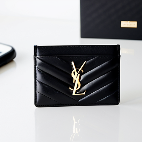 A minimalist Saint Laurent Monogram cardholder crafted from black quilted leather, adorned with a subtle gold YSL logo. The sleek cardholder is positioned on a clean, modern white desk next to a contemporary smartphone. The background is a soft-focus, bright, professional office environment with ample natural light. Captured with precise product photography, studio quality, sharp focus, high detail, perfect anatomy, correct proportions. Safe for work, appropriate content, fully clothed, professional, modest.